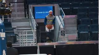 Steph Curry hits a warmup shot from the stands at Chase Center ahead of Warriors vs. Nuggets