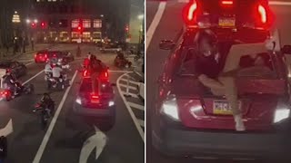 Video shows dirt bike rider smash windshield of car with children inside