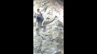 little kid passes grown man rock climbing