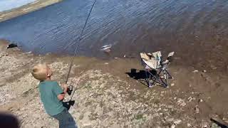 Elias catches big fish and fights to reel it in.