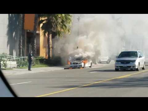 Burning BMW 3 series in front of Ferrari Newport Beach California Burning BMW 3 series in front of Ferrari Newport Beach California