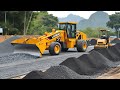 The best construction site with operating yellow LIUGONG motor grader spreading land and compactors