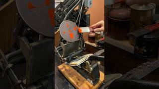 Using a tabletop printing press to print an orange image of a printing press