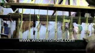 Weaving silk saree on a wooden loom in Madurai, Tamil Nadu