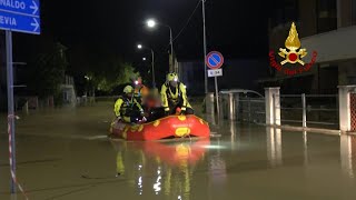 Italian fire brigade evacuate people by boat after deadly storms and flooding | AFP