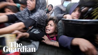 Palestinians scramble for food at soup kitchen in Khan Younis as they await ceasefire