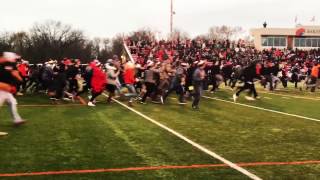 Students rush the field at Baker University