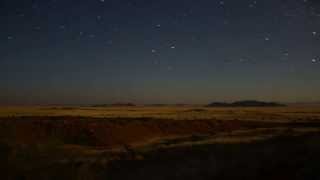 Starry night with light from moonrise behind camera - Time lapse.