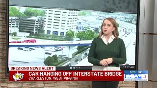 Car hanging off interstate bridge