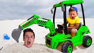 Senya and Dad are playing with a tractor on the beach. Storybook