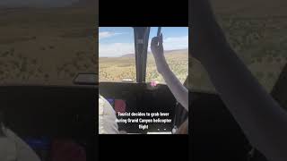 tourist grabs lever during helicopter flight….