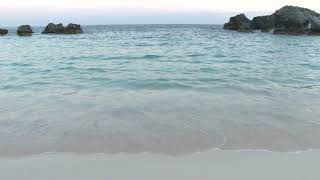 blue water hitting sandy bermuda beach