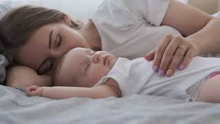 videoblocks mother lying with her newborn sleeping baby in bed bieqh1mhkb 1080  D