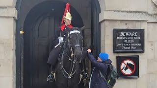 Special needs kid and his mum ❤️ give a carrot and money in the kings guard boot #kingsguard