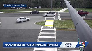 Video: Man arrested for driving backward on Flagler County road