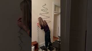 a Christmas tree with command hooks and Christmas lights #christmas #christmastree #christmasdecor