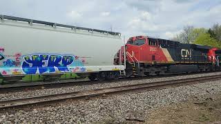 CN 3315, 2832 move an Eastbound freight train with ex-Stone Container box cars at Vicksburg, MI