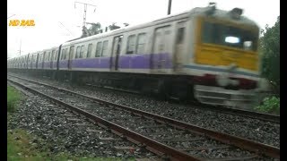 Gede local train just leaving Ranaghat railway junction in rain