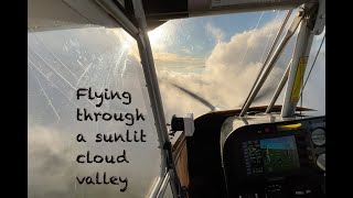 Flying through a beautifully sunlit cloud valley in mid winter.