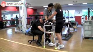 Erica C6/C7 quadriplegic walks with a walker and her recovery trainers May 2011