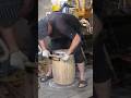 A whiskey barrel DIY. Manual sanding a wooden barrel...