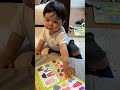 baby chooses his book to read