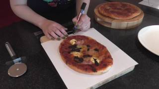 Cutting an oval pizza into equal area slices