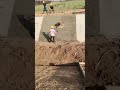 Ingenious construction worker making concrete drainage ditch