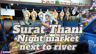 Surat Thani Night market next to the river. Street food Thailand.