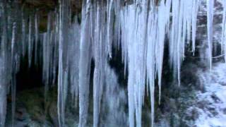 Behind an icy waterfall in frozen Fife