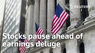 Stocks pause ahead of earnings deluge