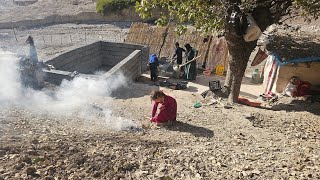 Nomadic life: cooperation of a mother and her children in the mountains to build a kitchen