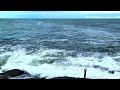 mesmerizing slow motion waves kissing the rocks