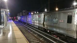 Zooming LIRR train overtakes one making a station stop at Farmingdale