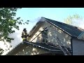 firefighter climbs through window of burning saginaw house chops roof with axe