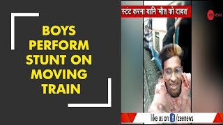 Four boys perform stunt on a moving local train in Mumbai