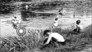Displaced Russian people washing clothes and bathing in river Mulde in Grimma, Ge...HD Stock Footage