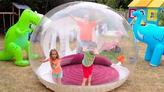 Katy and Max play with their Clear ball playhouse