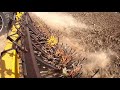 using a rotary hoe to break up big dirt clods.