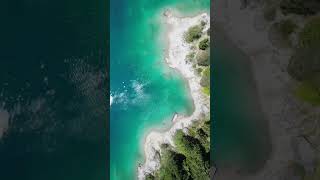 The turquoise surface of a charming mountain lake in Switzerland.