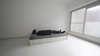 There is a bed in the minimalist room ... this can be folded small