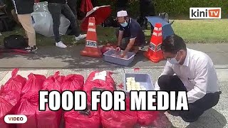 Media treated with food and drinks outside Istana Negara