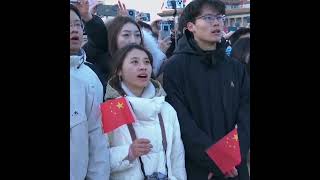 Crowds watch national flag being raised in Tiananmen Square on first day of new year