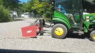 John Deere 1025r grading my gravel driveway with a five foot box blade