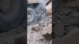 The truck tire got stuck by a big rock #creative inspiration