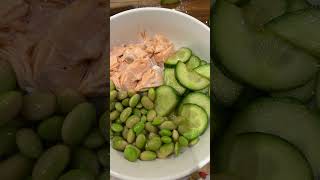 A salmon poke bowl: Cooked, buttered Salmon, edamame beans and soya sauced cucumber