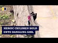 Heroic children in China save friend’s life by holding onto dangling girl’s hands