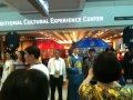 korean king and queen at airport with travelers