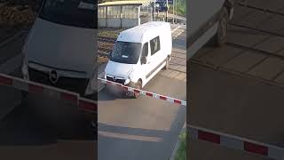 Train demolishes van stuck on tracks of railway crossing, slices vehicle in half