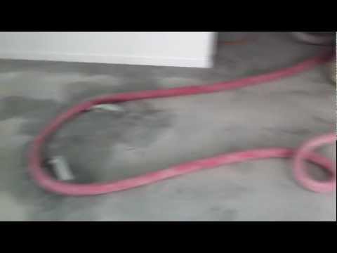 Vacuuming up concrete dust after grinding Vacuuming up concrete dust after grinding
